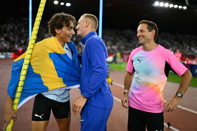 Sweden's Armand Duplantis (L) celebrates with US' Sam Kendricks (C) and France's Renaud Lavillenie after winning the men's pole vault during the IAAF Diamond League athletics meeting, at the Letzigrund Stadium, in Zurich on August 27, 2026. (Photo by Fabrice COFFRINI / AFP)