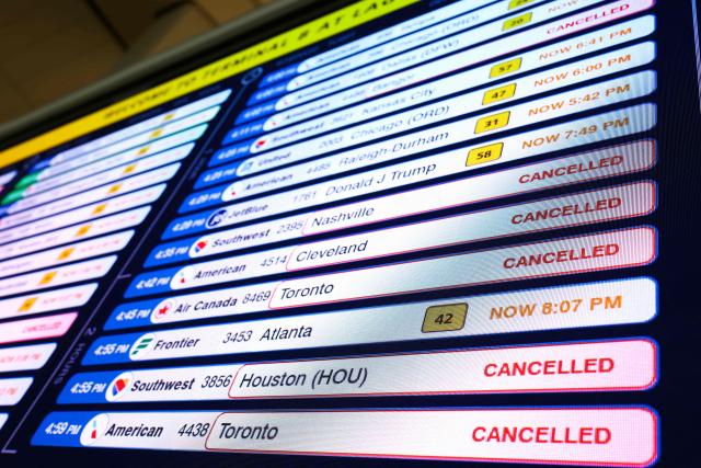 A flight information display board shows several flights cancelled at LaGuardia Airport in Queens, New York on August 27, 2026. Flight traffic at various New York area airports has been disrupted due to the weather, according to the FAA. (Photo by CHARLY TRIBALLEAU / AFP)
