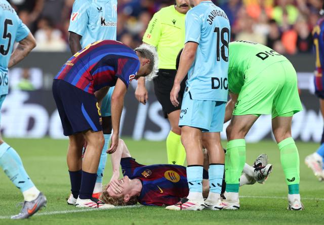 Barcelona's British forward #17 Anthony Gordon reacts on the ground after being injured during the Spanish league football match between FC Barcelona and Athletic Club Bilbao at Camp Nou Stadium in Barcelona on August 27, 2026. (Photo by Josep LAGO / AFP)