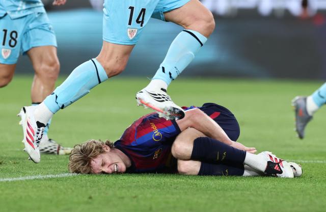 Barcelona's British forward #17 Anthony Gordon reacts on the ground after being injured during the Spanish league football match between FC Barcelona and Athletic Club Bilbao at Camp Nou Stadium in Barcelona on August 27, 2026. (Photo by Josep LAGO / AFP)