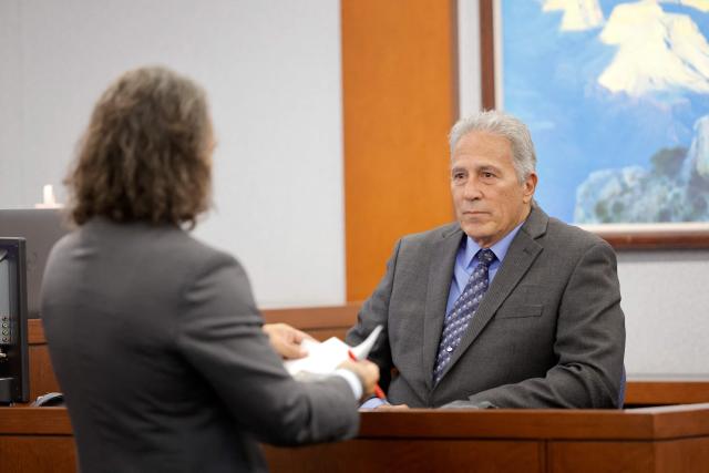 Former Las Vegas Metro Police Sergeant Stan Hyt listens to defense attorney Michael Sanft during the Duane Davis murder trial, related to the 1996 killing of rapper Tupac Shakur, in Clark County District Court at the Regional Justice Center in Las Vegas, Nevada, on August 27, 2026. The trial of the former gang leader accused of orchestrating the murder of rapper Tupac Shakur began on August 10, 30 years after one of America's most high-profile unresolved killings. The proceedings, expected to last a month, will likely not make clear who fired the shots that killed the California hip-hop legend on the night of September 7, 1996, while he was in Las Vegas to see a Mike Tyson boxing match. (Photo by Steve Marcus / POOL / AFP)