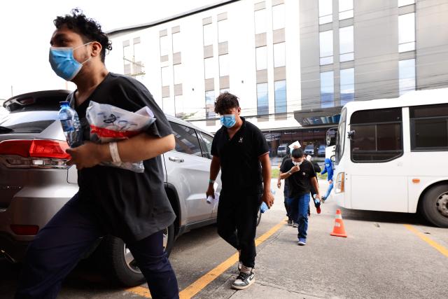 Mexican migrants arrive at the Mexican consulate after being deported aboard a US military aircraft to Ramon Villeda Morales International Airport in San Pedro Sula, 180 km north of Tegucigalpa, on August 27, 2026. (Photo by AFP)