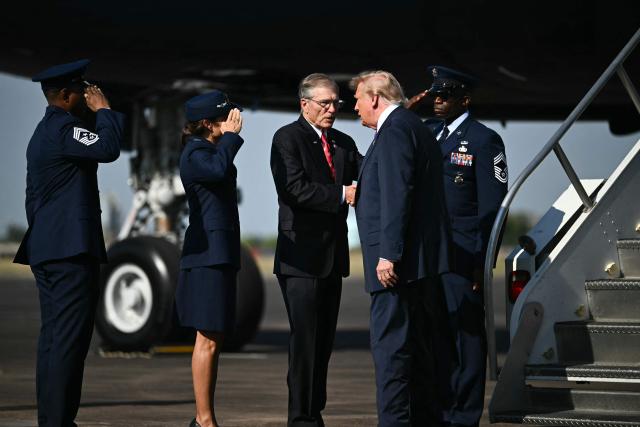 US President Donald Trump is greeted by US Representative Brian Babin, Republican of Texas, as he steps off Air Force One upon arrrival at Ellington Airport in Houston, Texas, on August 27, 2026. Trump is in Houston to headline a Republican National Committee (RNC) fundraiser to boost Ken Paxton's US Senate campaign. (Photo by Kent NISHIMURA / AFP)
