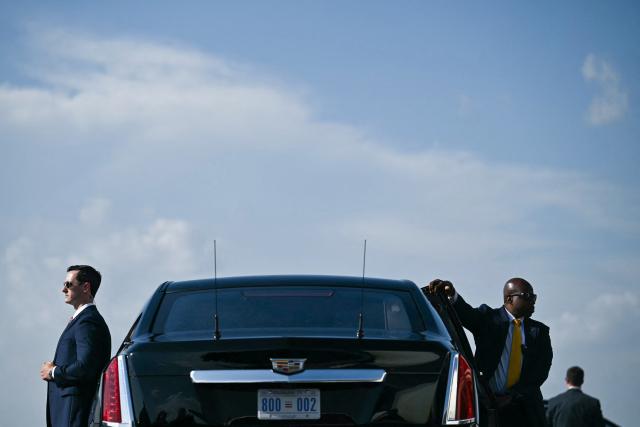 US Secret Service agents wait by President Donald Trump's limousine, known as The Beast, as he steps off Air Force One upon arrrival at Ellington Airport in Houston, Texas, on August 27, 2026. Trump is in Houston to headline a Republican National Committee (RNC) fundraiser to boost Ken Paxton's US Senate campaign. (Photo by Kent NISHIMURA / AFP)