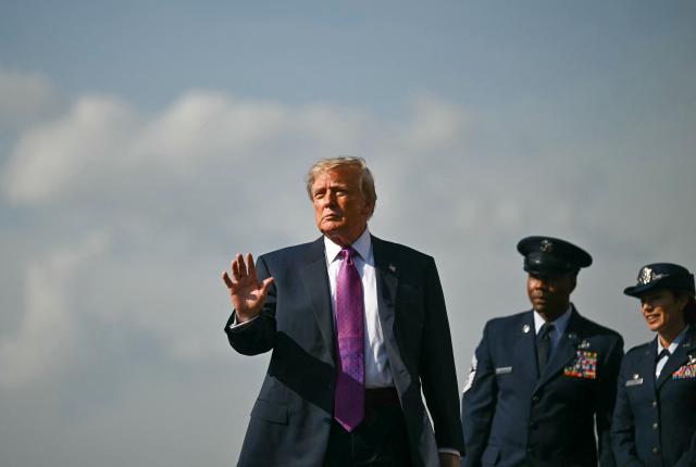 US President Donald Trump waves after stepping off Air Force One upon arrrival at Ellington Airport in Houston, Texas, on August 27, 2026. Trump is in Houston to headline a Republican National Committee (RNC) fundraiser to boost Ken Paxton's US Senate campaign. (Photo by Kent NISHIMURA / AFP)
