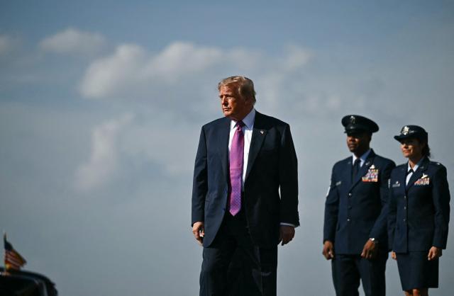 US President Donald Trump walks on tharmac after as he stepping off Air Force One upon arrrival at Ellington Airport in Houston, Texas, on August 27, 2026. Trump is in Houston to headline a Republican National Committee (RNC) fundraiser to boost Ken Paxton's US Senate campaign. (Photo by Kent NISHIMURA / AFP)