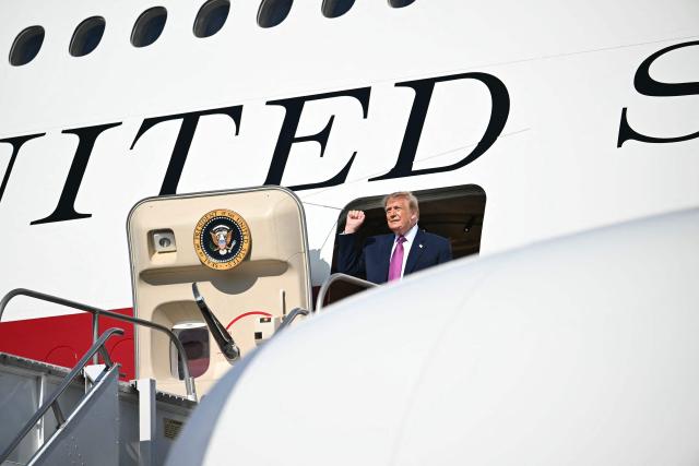 US President Donald Trump clenches his fist as he steps off Air Force One upon arrival at Ellington Airport in Houston, Texas, on August 27, 2026. Trump is in Houston to headline a Republican National Committee (RNC) fundraiser to boost Ken Paxton's US Senate campaign. (Photo by Kent NISHIMURA / AFP)