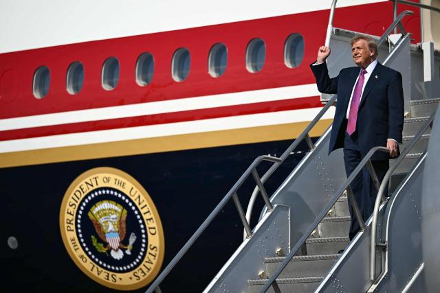 US President Donald Trump clenches his fist as he steps off Air Force One upon arrival at Ellington Airport in Houston, Texas, on August 27, 2026. Trump is in Houston to headline a Republican National Committee (RNC) fundraiser to boost Ken Paxton's US Senate campaign. (Photo by Kent NISHIMURA / AFP)