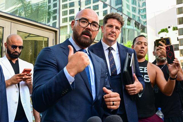 Joseph D. McBride (C-L), attorney for Andrew Tate and Tristan Tate, speaks to reporters, flanked by attorney Andrew Ford (C-R), after a court hearing for the brothers' extradition at the Wilkie D. Ferguson Jr. Federal Courthouse in Miami on August 27, 2026. US authorities detained the self-professed misogynist and his younger sibling on July 18, 2026 after British prosecutors announced new charges of rape, sex trafficking and assault. (Photo by GIORGIO VIERA / AFP)