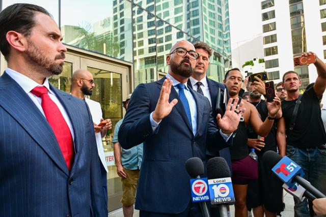 Joseph D. McBride (C), attorney for Andrew Tate and Tristan Tate, speaks to reporters after a court hearing for the brothers' extradition at the Wilkie D. Ferguson Jr. Federal Courthouse in Miami on August 27, 2026. US authorities detained the self-professed misogynist and his younger sibling on July 18, 2026 after British prosecutors announced new charges of rape, sex trafficking and assault. (Photo by GIORGIO VIERA / AFP)