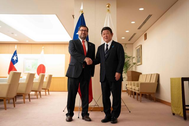 Japan's Foreign Minister Toshimitsu Motegi (R) and Chile's Foreign Minister Francisco Perez Mackenna shake hands prior to their meeting at the Ministry of Foreign Affairs in Tokyo on August 28, 2026. (Photo by Yuichi YAMAZAKI / AFP)