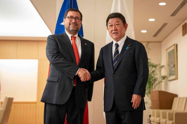 Japan's Foreign Minister Toshimitsu Motegi (R) and Chile's Foreign Minister Francisco Perez Mackenna shake hands prior to their meeting at the Ministry of Foreign Affairs in Tokyo on August 28, 2026. (Photo by Yuichi YAMAZAKI / AFP)