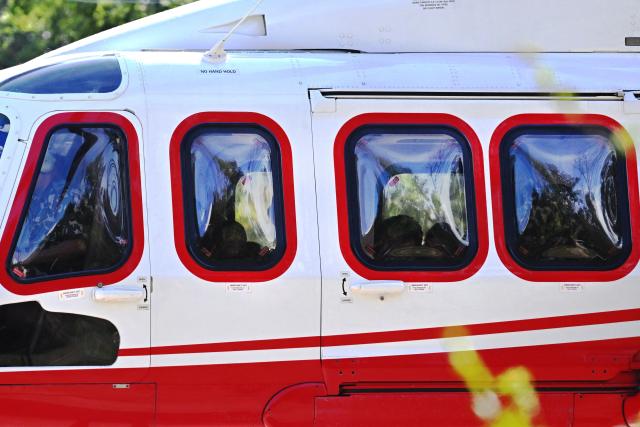 School children sit on board a helicopter on a transit flight back to their family at Trishuli camp after being stranded by flash floods in Nepal's Nuwakot district on August 28, 2026. China and Nepal warned of fresh flooding risks, complicating rescuers' search for more than 1,400 people missing after a deadly deluge and landslides swept away entire villages along their remote Himalayan border. (Photo by Arun SANKAR / AFP)