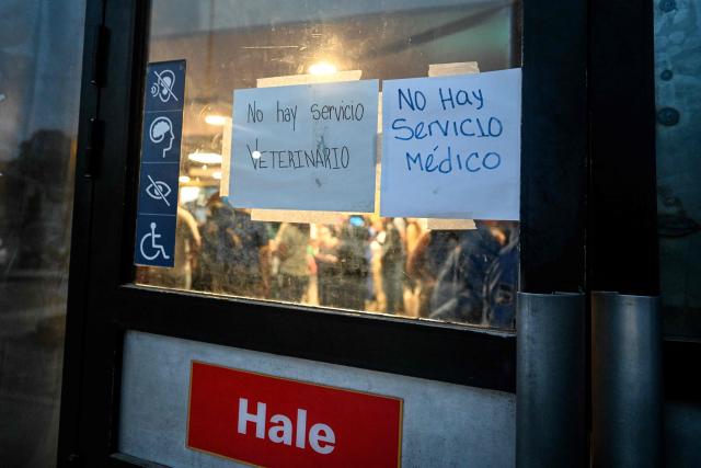 Signs read in Spanish "No veterinary services" and "No medical services" at the entrance to a McDonald's turned into a makeshift health centre 64 days after the 7.2 and 7.5-magnitude earthquakes in Caraballeda, La Guaira state, Venezuela on August 27, 2026. Two 7.2 and 7.5-magnitude earthquakes struck Venezuela on June 24, 2026. A McDonald's restaurant in the hard-hit Caraballeda area served as a makeshift health centre until August 27, more than two months after the disaster. (Photo by Maryorin Mendez / AFP)