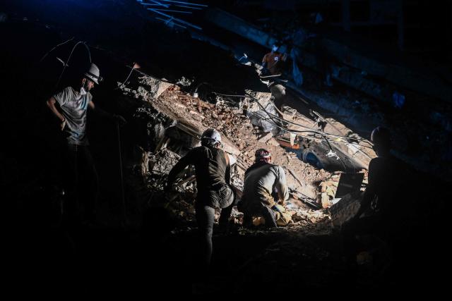 Volunteer rescuers search amid the rubble of a collapsed building 64 days after the 7.2 and 7.5-magnitude earthquakes in Caraballeda, La Guaira state, Venezuela on August 27, 2026. Two 7.2 and 7.5-magnitude earthquakes struck Venezuela on June 24, 2026. A McDonald's restaurant in the hard-hit Caraballeda area served as a makeshift health center until August 27, more than two months after the disaster. (Photo by Maryorin Mendez / AFP)
