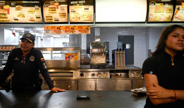 A Venezuelan police officer and a nurse stand at the counter of a McDonald's turned into a makeshift health centre 64 days after the 7.2 and 7.5-magnitude earthquakes in Caraballeda, La Guaira state, Venezuela on August 27, 2026. Two 7.2 and 7.5-magnitude earthquakes struck Venezuela on June 24, 2026. A McDonald's restaurant in the hard-hit Caraballeda area served as a makeshift health centre until August 27, more than two months after the disaster. (Photo by Maryorin Mendez / AFP)