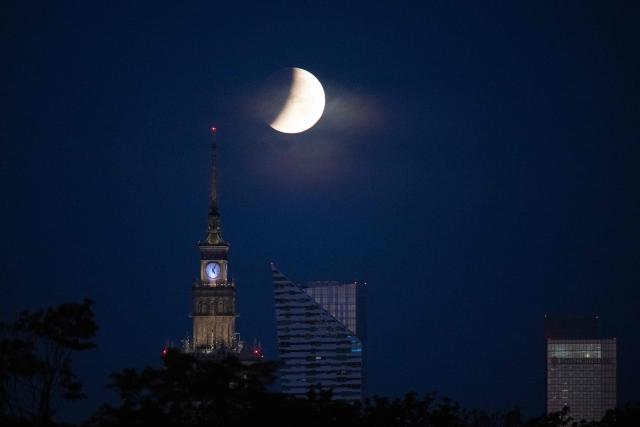 The full moon, also known as the Sturgeon Moon, sets over Warsaw's skyscrapers during a partial lunar eclipse in Warsaw on August 28, 2026. (Photo by Sergei GAPON / AFP)