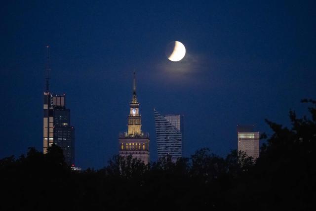 The full moon, also known as the Sturgeon Moon, sets over Warsaw's skyscrapers during a partial lunar eclipse in Warsaw on August 28, 2026. (Photo by Sergei GAPON / AFP)