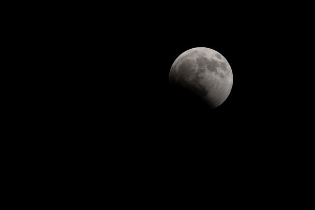The Moon enters the Earth's umbra during a partial lunar eclipse over Brazos Bend State Park in Needville, Texas on August 27, 2026. (Photo by RONALDO SCHEMIDT / AFP)