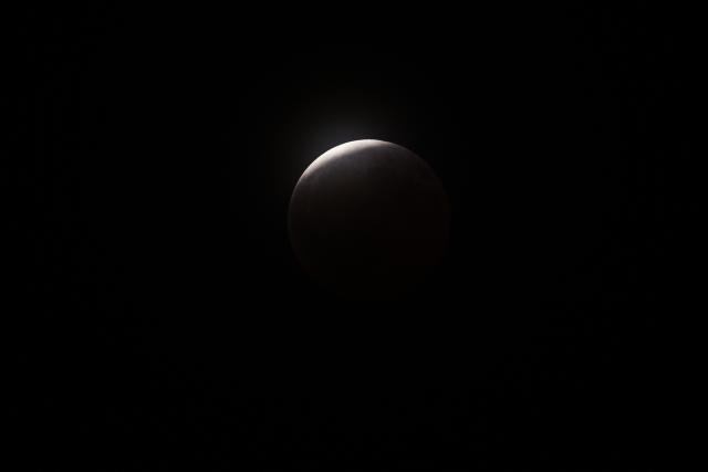 A maximum portion of the Moon is within the Earth's umbra during a partial lunar eclipse over Brazos Bend State Park in Needville, Texas on August 27, 2026. (Photo by RONALDO SCHEMIDT / AFP)