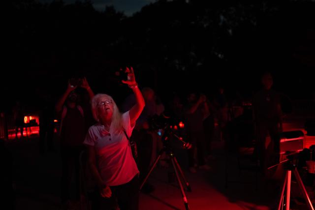 People observe the partial lunar eclipse from the George Observatory at Brazos Bend State Park in Needville, Texas on August 27, 2026. (Photo by RONALDO SCHEMIDT / AFP)
