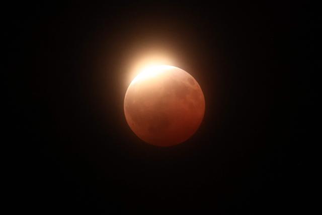 A maximum portion of the Moon is within the Earth's umbra during a partial lunar eclipse as seen from the Trona Pinnacles area near Trona, California on August 27, 2026. (Photo by David Swanson / AFP)