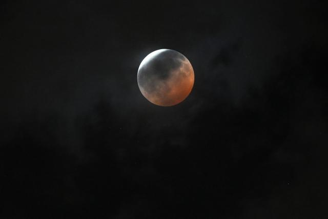 A maximum portion of the Moon is within the Earth's umbra during a partial lunar eclipse over Guatemala City on August 27, 2026. (Photo by Johan ORDONEZ / AFP)