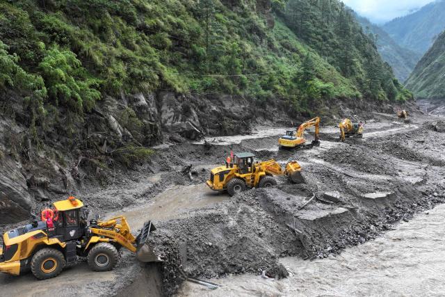 Workers repair a section of road leading to Gyirong Port which was damaged after a mudslide two days earlier, in Gyirong County, in China’s western Tibet region on August 28, 2026. (Photo by CNS / AFP) / China OUT