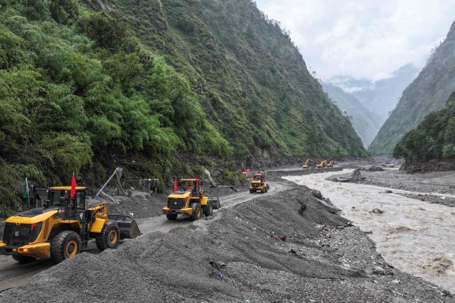 Workers repair a section of a road leading to Gyirong Port which was damaged after a mudslide two days earlier, in Gyirong County, in China’s western Tibet region on August 28, 2026. (Photo by CNS / AFP) / China OUT