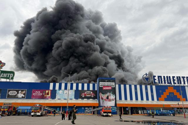 Ukrainian rescue personnel work to extinguish a fire in a damaged shopping mall following an air attack in Zaporizhzhia on August 28, 2026, amid the Russian invasion of Ukraine. (Photo by Darya NAZAROVA / AFP)
