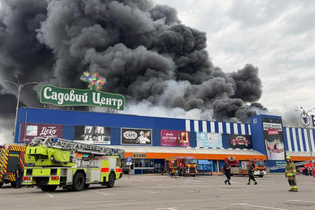 Ukrainian rescue personnel work to extinguish a fire in a damaged shopping mall following an air attack in Zaporizhzhia on August 28, 2026, amid the Russian invasion of Ukraine. (Photo by Darya NAZAROVA / AFP)