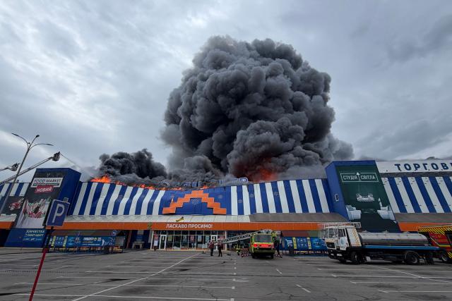 Ukrainian rescue personnel work to extinguish a fire in a damaged shopping mall following an air attack in Zaporizhzhia on August 28, 2026, amid the Russian invasion of Ukraine. (Photo by Darya NAZAROVA / AFP)