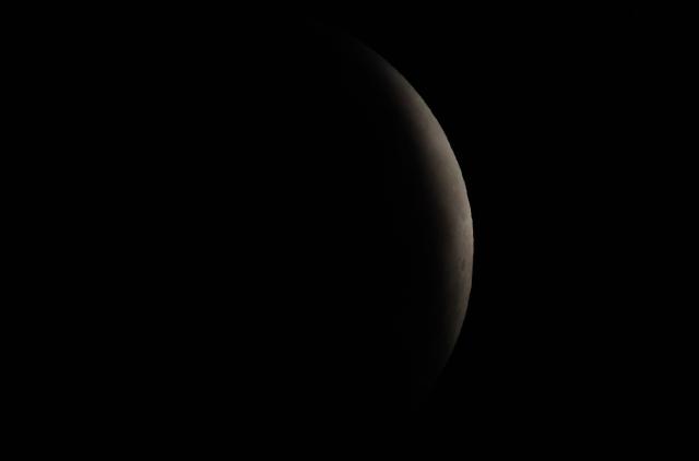 A maximum portion of the Moon is within the Earth's umbra during a partial lunar eclipse as seen from Madrid on August 28, 2026. (Photo by Thomas COEX / AFP)