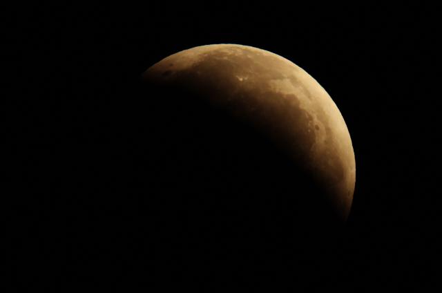 A picture taken from Madrid on August 28, 2026 shows the Moon within the Earth's umbra during a partial lunar eclipse. (Photo by Thomas COEX / AFP)