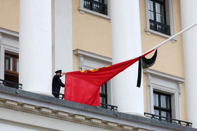 The royal flag with a black ribbon is raised to half-mast by members of the Royal Guards from the balcony of the royal palace after King Harald V of Norway passed away in Oslo, Norway on August 28, 2026. King Harald V of Norway, who died on August 28, 2026 aged 89, remained a unifying figure in his country until the very end, a pillar of stability amid a string of family scandals that tarnished the final years of his reign. (Photo by Odd ANDERSEN / AFP)
