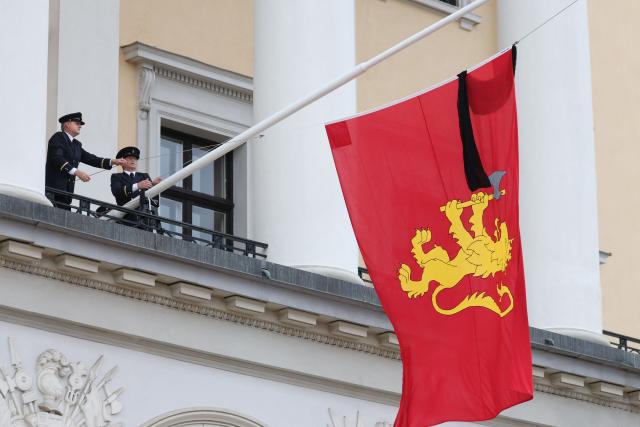 The royal flag with a black ribbon is raised to half-mast by members of the Royal Guards from the balcony of the royal palace after King Harald V of Norway passed away in Oslo, Norway on August 28, 2026. King Harald V of Norway, who died on August 28, 2026 aged 89, remained a unifying figure in his country until the very end, a pillar of stability amid a string of family scandals that tarnished the final years of his reign. (Photo by Odd ANDERSEN / AFP)