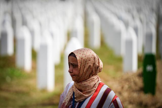 A woman visits the memorial cemetery in the village of Potocari, following the death of former Bosnian Serb military chief Ratko Mladic near the eastern Bosnian town of Srebrenica, on August 28, 2026. Mladic died in a prison hospital in The Hague aged 84 after suffering several strokes. He was priorly convicted of genocide, crimes against humanity and war crimes, was known as the "Butcher of Bosnia" for his role in the 1995 Srebrenica massacre, Europe's worst atrocity since World War II. (Photo by Nidal Saljic / AFP)