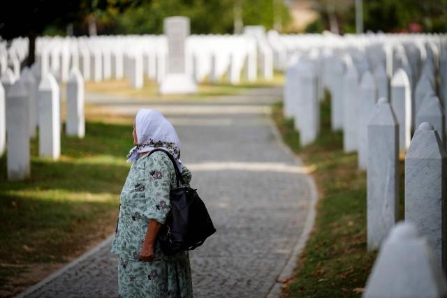 A woman visits the memorial cemetery in the village of Potocari, following the death of former Bosnian Serb military chief Ratko Mladic near the eastern Bosnian town of Srebrenica, on August 28, 2026. Mladic died in a prison hospital in The Hague aged 84 after suffering several strokes. He was priorly convicted of genocide, crimes against humanity and war crimes, was known as the "Butcher of Bosnia" for his role in the 1995 Srebrenica massacre, Europe's worst atrocity since World War II. (Photo by Nidal Saljic / AFP)