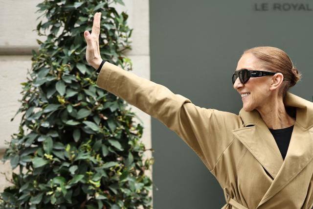 Canadian singer Celine Dion acknowledges fans as she arrives at Hotel Le Royal Monceau in Paris on August 28, 2026, ahead of her series of concerts in the French capital. Celine Dion, 58, announced in late March, in a video and a message projected onto the Eiffel Tower, her return to the stage, in Paris, after six years away from the public, between the pandemic and persistent health problems. She has suffered since 2022 from stiff person syndrome, a rare and incurable neurological condition. (Photo by SIMON WOHLFAHRT / AFP)