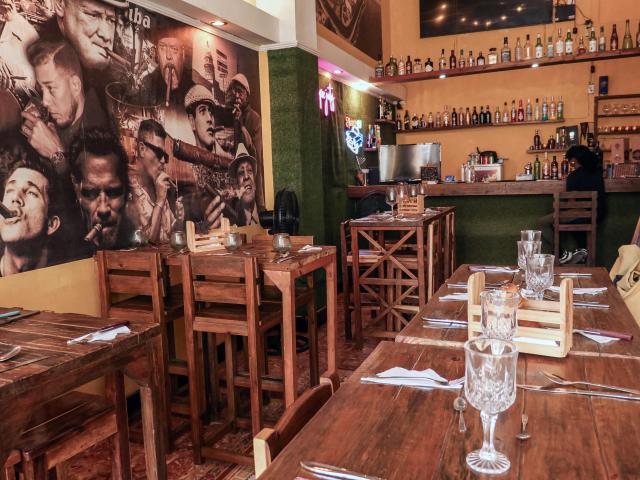 Empty tables are seen inside El Balcon de los Hermanos restaurant in Havana on August 22, 2026. Opening a restaurant in today's Cuba defies all logic. Amid power outages, shortages of supplies and a sharp decline in tourism, some Cubans keep their businesses open while others even take the risk of launching new establishments. (Photo by ADALBERTO ROQUE / AFP)