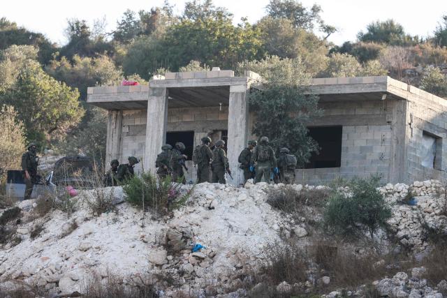 Israeli soldiers gather outside a home under construction following a drone strike killing of three Palestinian, on the western outskirts of the northern city of Jenin, in the Israeli-occupied West Bank on August 28, 2026. (Photo by Jaafar ASHTIYEH / AFP)