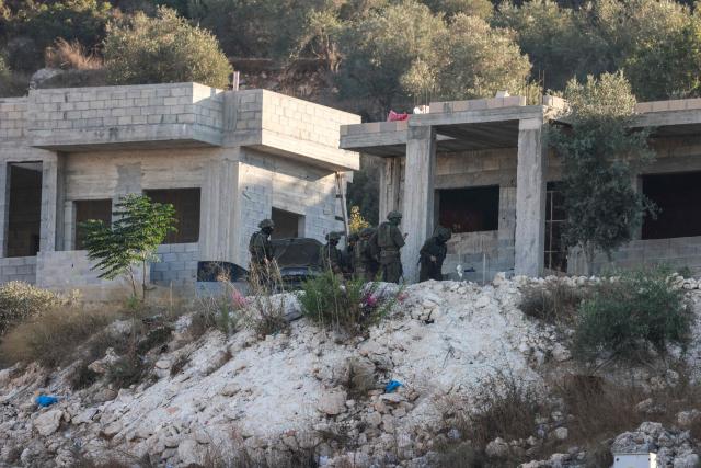 Israeli soldiers gather outside a home under construction following a drone strike killing of three Palestinian, on the western outskirts of the northern city of Jenin, in the Israeli-occupied West Bank on August 28, 2026. (Photo by Jaafar ASHTIYEH / AFP)