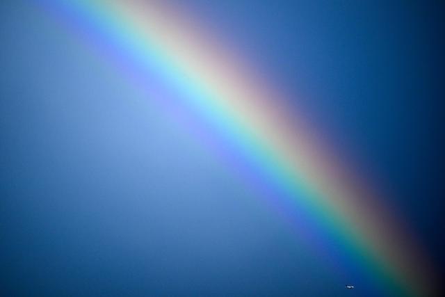TOPSHOT - Airbus A319-112 aircraft of German airline Lufthansa flies past a rainbow in Frankfurt am Main, western Germany, on August 28, 2026. (Photo by Kirill KUDRYAVTSEV / AFP)