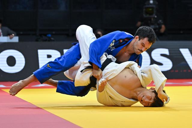 South Korea's Channyeong Kim (white) and Spain's David Garcia Torne compete in their men's under 66kg bronze medal bout at the Lausanne Grand Slam judo tournament, part of the IJF World Judo Tour, in Prilly on August 28, 2026. (Photo by Fabrice COFFRINI / AFP)