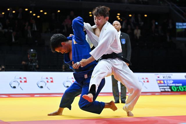 South Korea's Channyeong Kim (white) and Spain's David Garcia Torne compete in their men's under 66kg bronze medal bout at the Lausanne Grand Slam judo tournament, part of the IJF World Judo Tour, in Prilly on August 28, 2026. (Photo by Fabrice COFFRINI / AFP)
