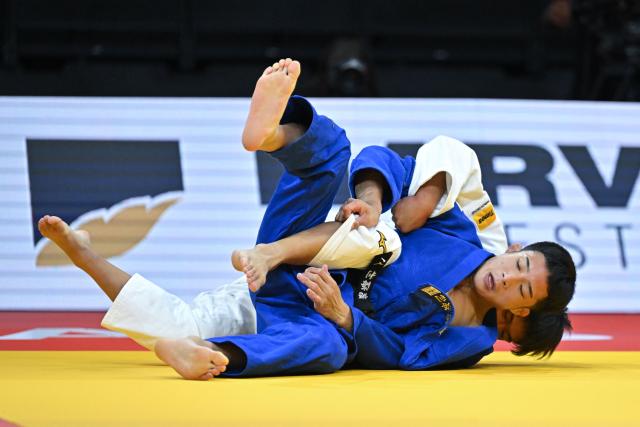 Japan's Shinsei Hattori (white) and Japan's Kairi Kentoku compete in their men's under 66kg gold medal bout at the Lausanne Grand Slam judo tournament, part of the IJF World Judo Tour, in Prilly on August 28, 2026. (Photo by Fabrice COFFRINI / AFP)