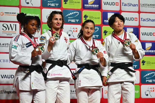 (From L) Silver medallist France's Sarah Leonie Cysique, gold medallist Georgia's Eteri Liparteliani, bronze medallists Italy's Giulia Carna and Japan's Ayami Takano pose with their medals after the women's under 57kg category final event at the Lausanne Grand Slam judo tournament, part of the IJF World Judo Tour, in Prilly on August 28, 2026. (Photo by Fabrice COFFRINI / AFP)
