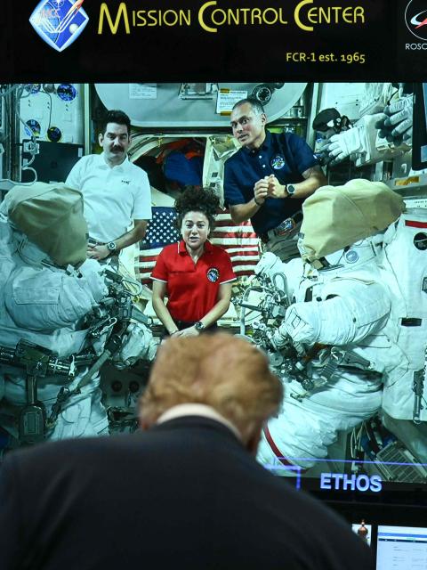 US President Donald Trump looks on as crew members on the International Space Station (ISS) are displayed on a screen at the Mission Control Center at NASA Lyndon B. Johnson Space Center in Houston, Texas, on August 28, 2026. During his visit, President Trump honored the Artemis II crew with the Congressional Space Medal of Honor for their historic mission around the Moon and signed an executive order that aims to create a US Space Academy. (Photo by Kent NISHIMURA / AFP)