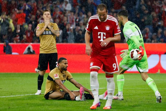 Stuttgart's German defender #04 Josha Vagnoman (2L) reacts after scoring an own goal (3-1) during the German first division Bundesliga football match between FC Bayern Munich and VfB Stuttgart in Munich, southern Germany, on August 28, 2026. (Photo by Alexandra BEIER / AFP) / DFL REGULATIONS PROHIBIT ANY USE OF PHOTOGRAPHS AS IMAGE SEQUENCES AND/OR QUASI-VIDEO