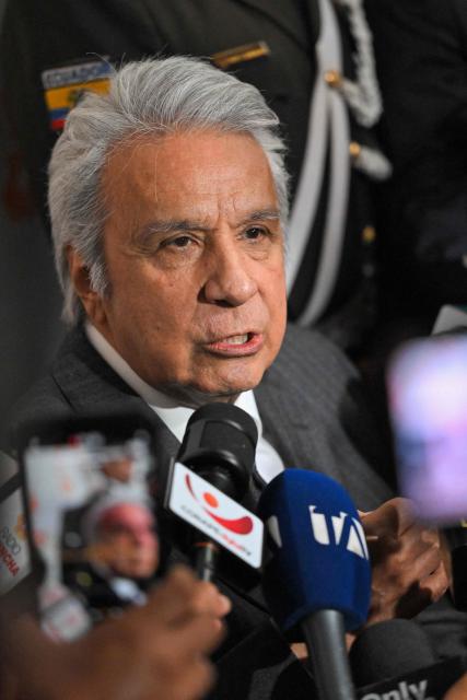 (FILES) Ecuador's former president (20172021) Lenin Moreno speaks with the media as he leaves the National Court of Justice over a corruption case in Quito, on May 11, 2026. An Ecuadoran court on August 28, 2026 convicted former leftist president Lenin Moreno of accepting millions of dollars in bribes linked to the construction of a hydroelectric plant. The Attorney General's Office said Moreno, who served as president from 2017 to 2021, was among four people convicted in the case involving a plant built by Chinese company Sinohydro during his tenure as vice president. (Photo by Rodrigo BUENDIA / AFP)